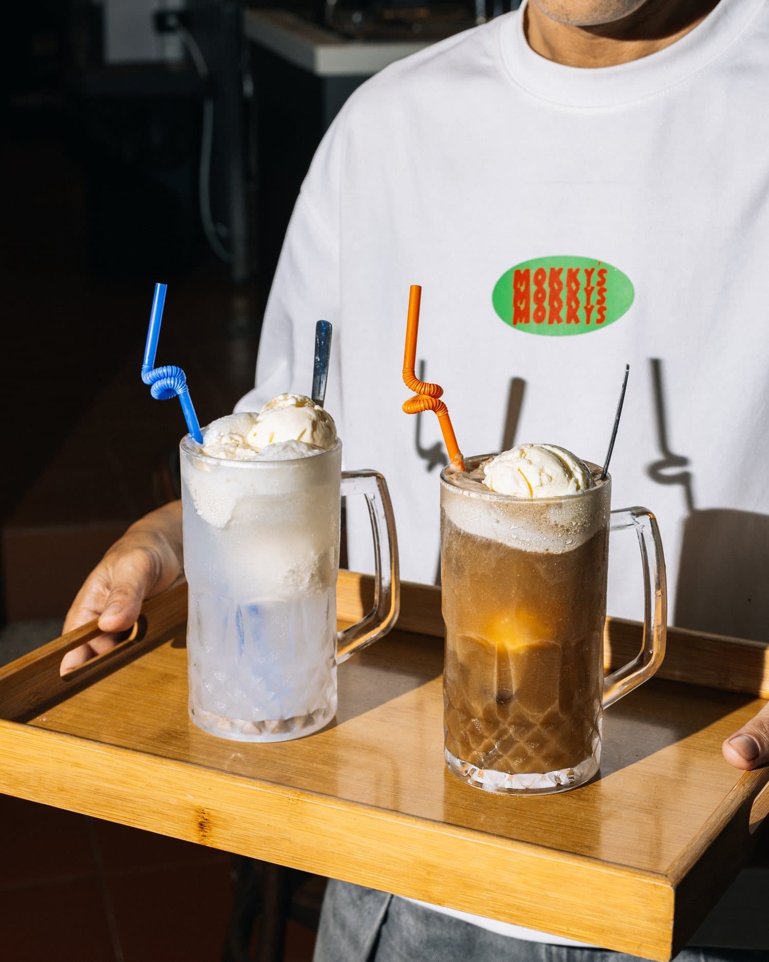 Crew carrying a tray of milkshakes